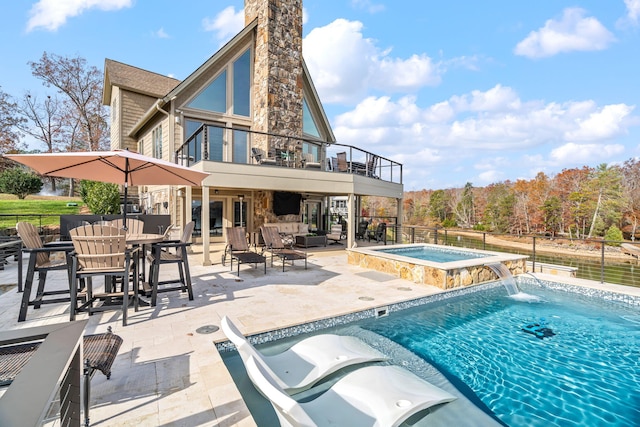 view of pool featuring an in ground hot tub, a patio area, an outdoor living space, and pool water feature