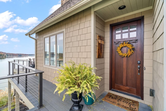 doorway to property with a water view