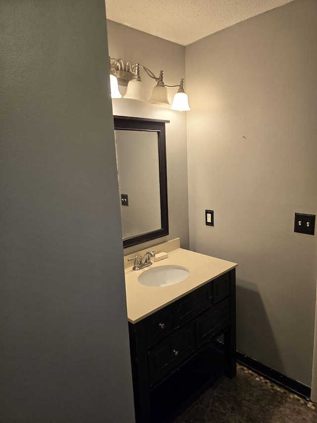 bathroom with a textured ceiling and vanity