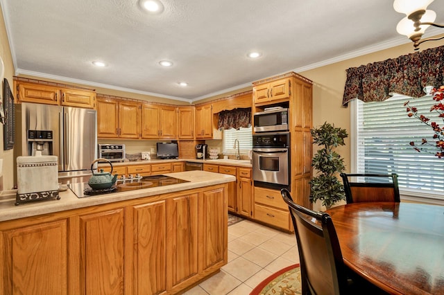 135 Charles Cir SE, Cleveland, TN 37323 - kitchen with appliances with stainless steel finishes, light countertops, healthy amount of natural light, ornamental molding, and light tile patterned floors