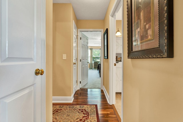 135 Charles Cir SE, Cleveland, TN 37323 - hallway with dark wood-style flooring and a textured ceiling