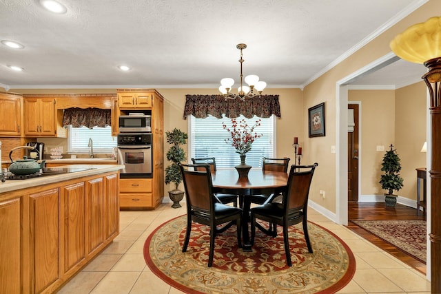 135 Charles Cir SE, Cleveland, TN 37323 - dining space with a chandelier, light tile patterned flooring, ornamental molding, and recessed lighting