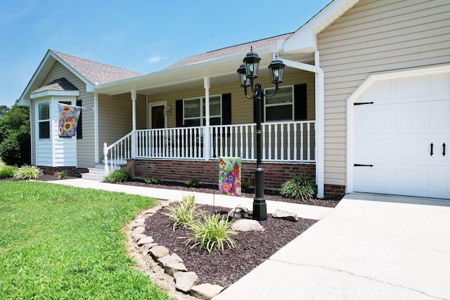 135 Charles Cir SE, Cleveland, TN 37323 - view of front of property featuring a porch, an attached garage, roof with shingles, and a front yard