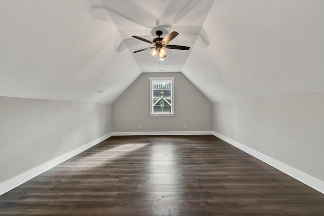 additional living space featuring dark hardwood / wood-style floors, ceiling fan, and vaulted ceiling