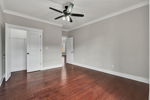 unfurnished bedroom featuring ceiling fan, a closet, dark hardwood / wood-style floors, and ornamental molding