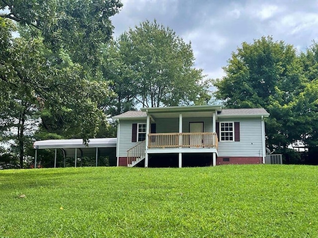 rear view of property with a porch, a yard, and central AC