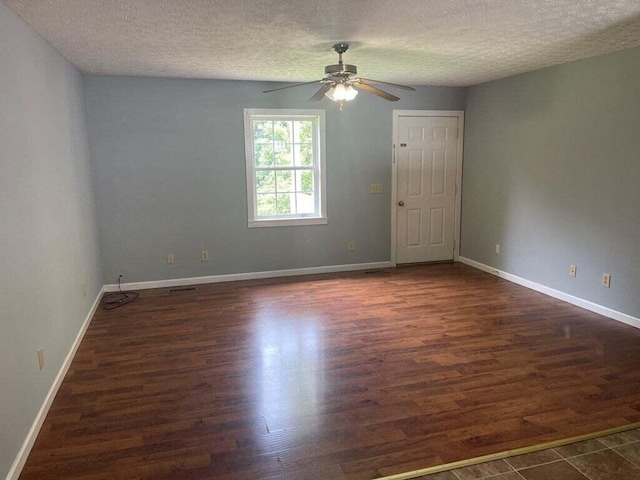 spare room with ceiling fan, dark hardwood / wood-style flooring, and a textured ceiling