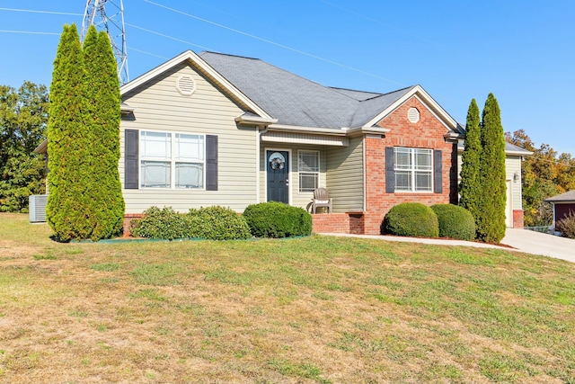 single story home featuring a front yard, brick siding, and roof with shingles