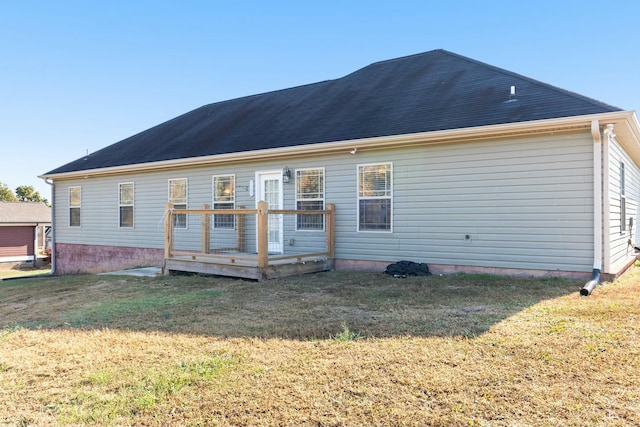 back of house with a deck and a yard