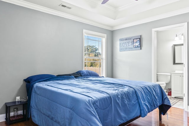 bedroom featuring visible vents, ornamental molding, a ceiling fan, wood finished floors, and connected bathroom