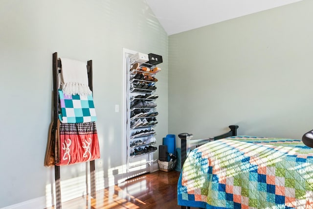 bedroom featuring vaulted ceiling and wood finished floors