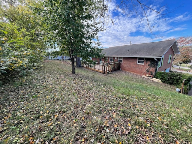 view of yard featuring a wooden deck