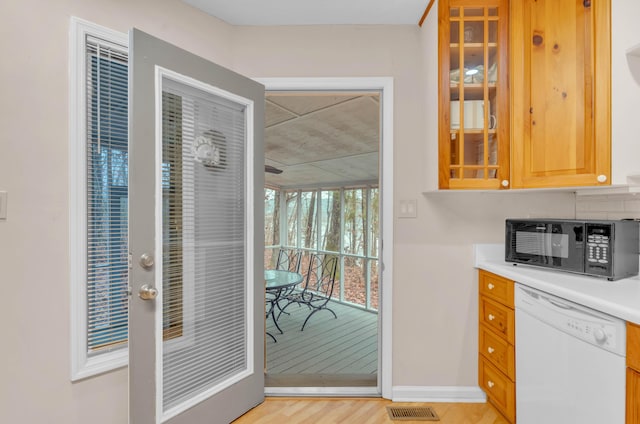 kitchen featuring white dishwasher and light hardwood / wood-style floors