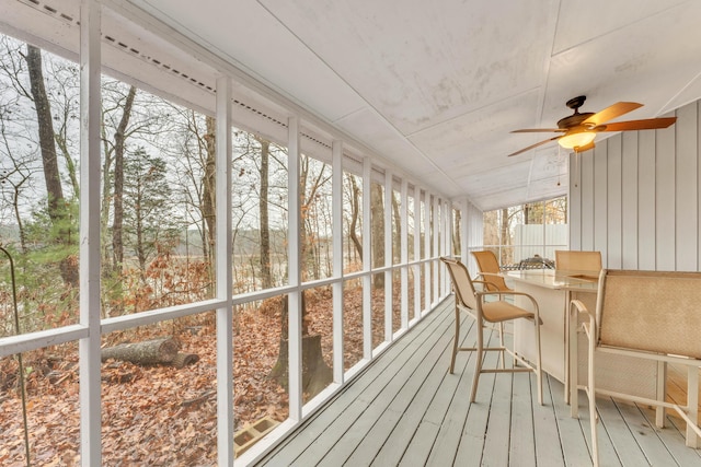 sunroom featuring ceiling fan and a healthy amount of sunlight