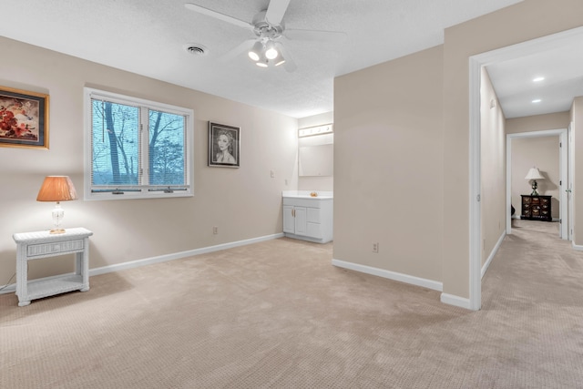 interior space featuring ceiling fan and a textured ceiling