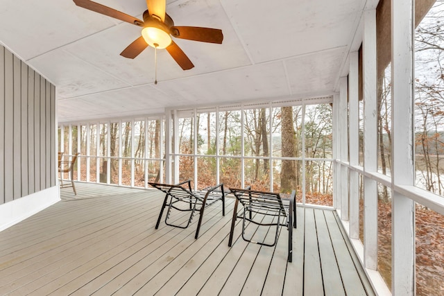 unfurnished sunroom with ceiling fan