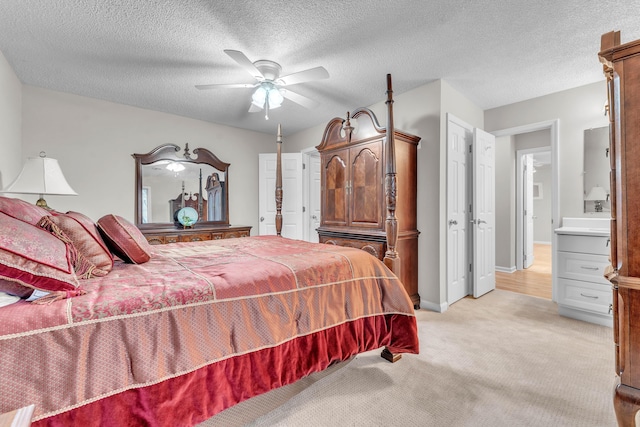 carpeted bedroom with ceiling fan and a textured ceiling