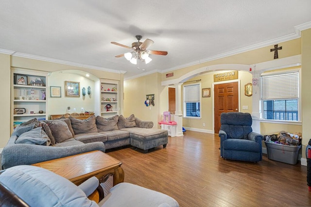 living room with crown molding, hardwood / wood-style floors, and built in shelves