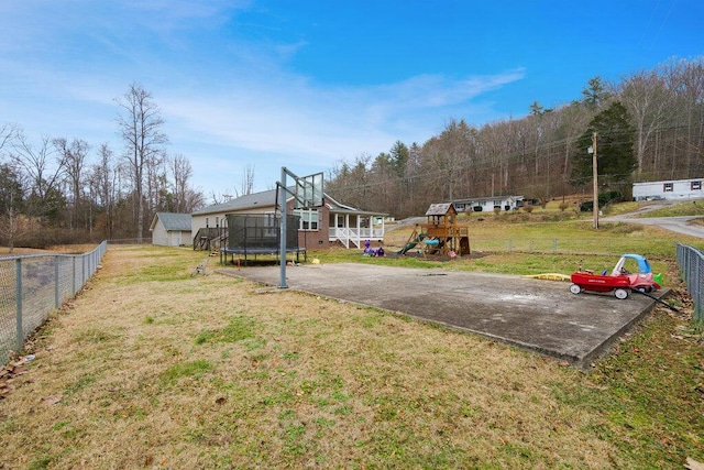 view of yard with a playground and a trampoline