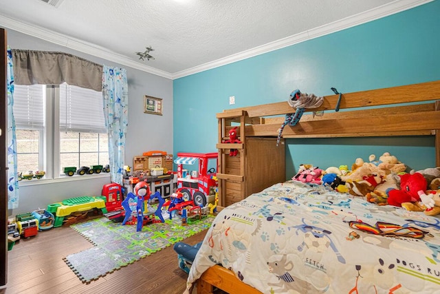 bedroom featuring ornamental molding, hardwood / wood-style floors, and a textured ceiling