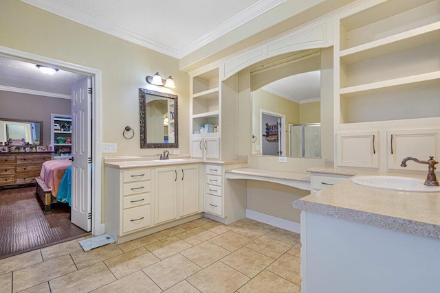 bathroom featuring tile patterned flooring, ornamental molding, vanity, and built in shelves