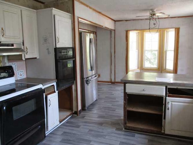 kitchen with oven, hardwood / wood-style floors, white cabinetry, electric range, and stainless steel fridge