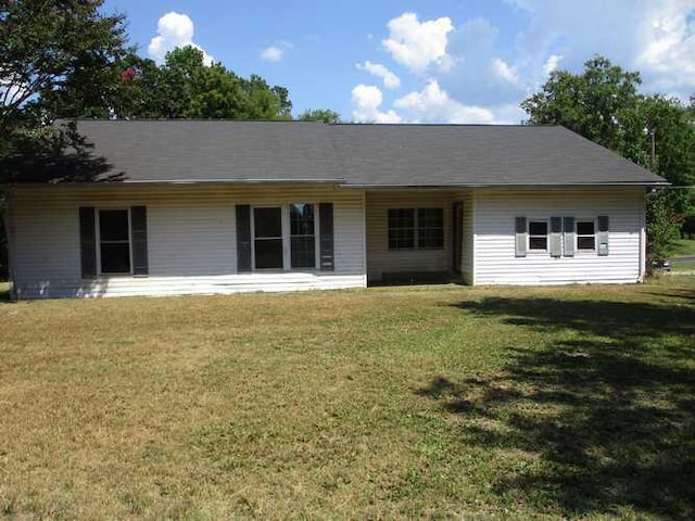 rear view of house with a yard