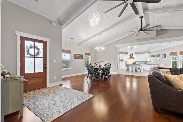 foyer entrance with dark wood-type flooring, a wealth of natural light, and lofted ceiling with beams