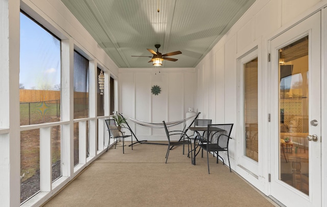 sunroom with ceiling fan and a wealth of natural light