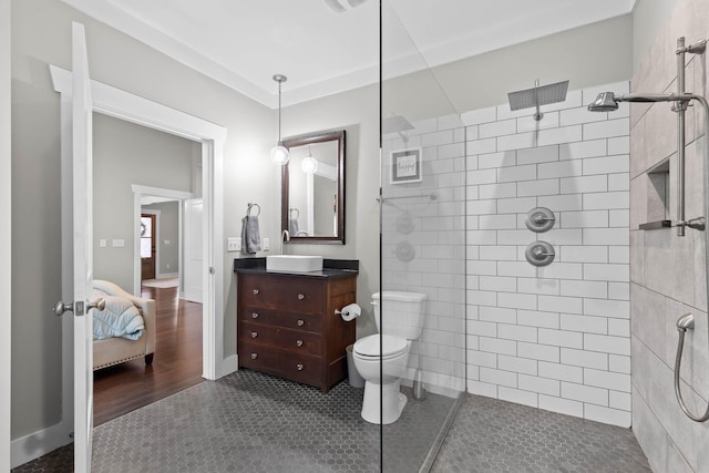 bathroom featuring vanity, tile patterned flooring, and tiled shower