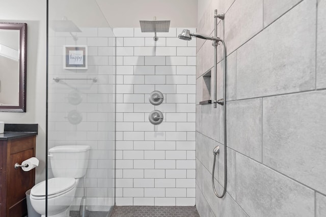 bathroom with toilet and a tile shower