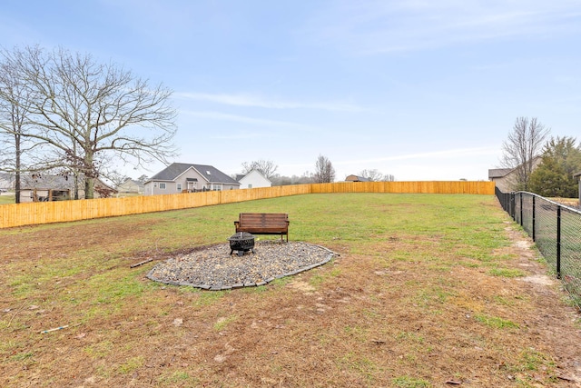 view of yard with a fire pit