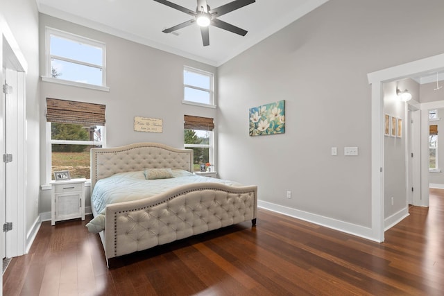 bedroom with ceiling fan, multiple windows, dark hardwood / wood-style floors, and high vaulted ceiling