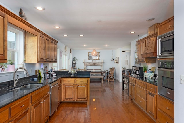 kitchen with kitchen peninsula, dark hardwood / wood-style flooring, sink, and appliances with stainless steel finishes