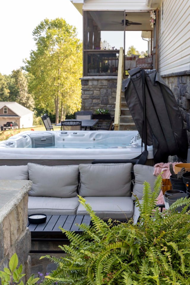 view of patio / terrace with a sunroom and a hot tub