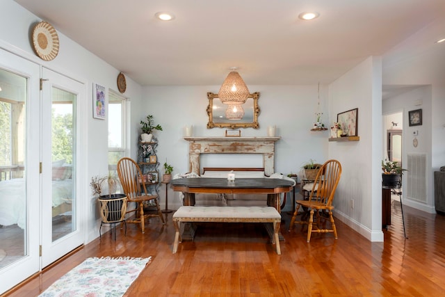 dining space with hardwood / wood-style flooring