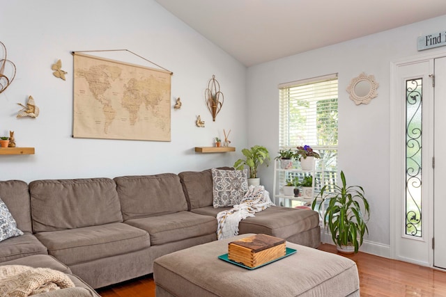 living room featuring hardwood / wood-style flooring and lofted ceiling