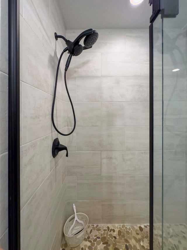 bathroom with a tile shower