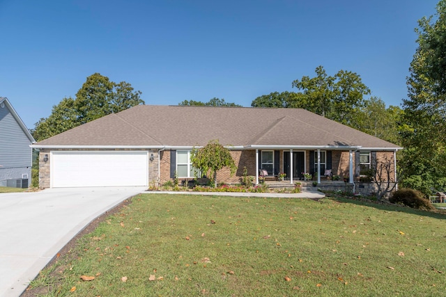 ranch-style home featuring a garage and a front lawn