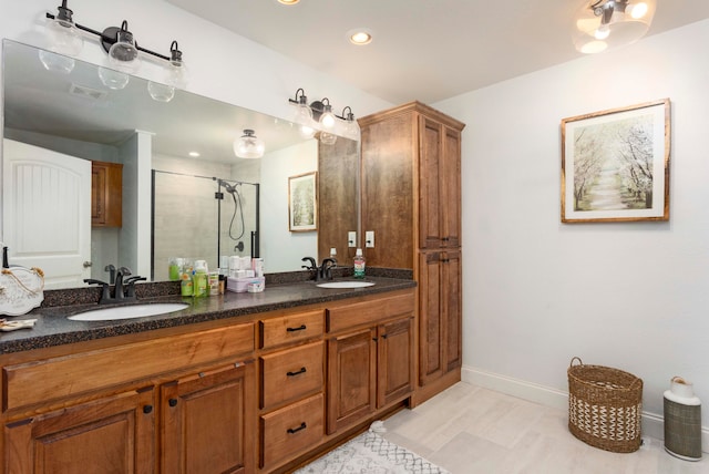 bathroom with vanity and a shower with door