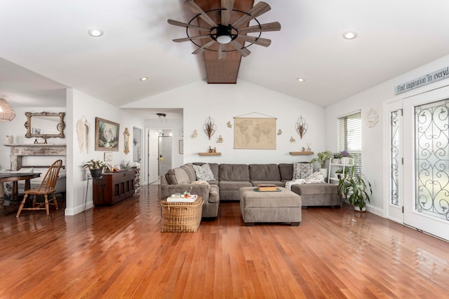 living room with hardwood / wood-style floors, ceiling fan, and lofted ceiling