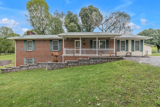 single story home with covered porch and a front yard