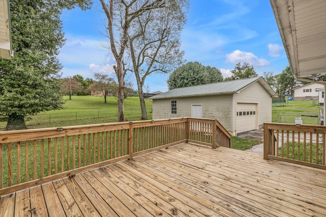 wooden terrace with a yard, an outbuilding, and a garage