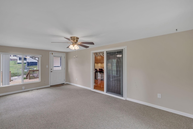 empty room with carpet flooring and ceiling fan