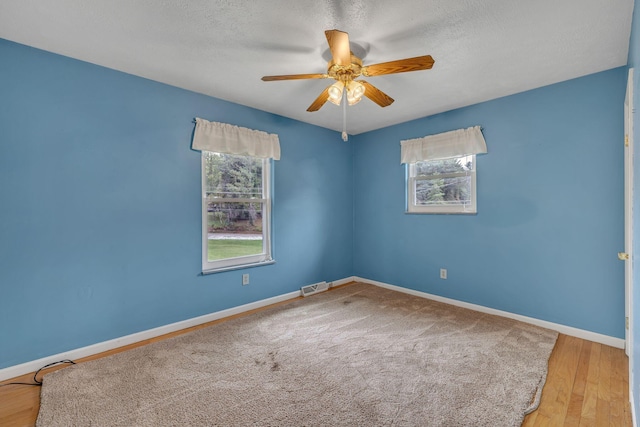 spare room featuring hardwood / wood-style floors, a textured ceiling, and ceiling fan