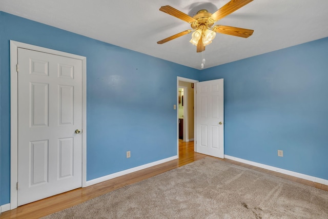 unfurnished bedroom with ceiling fan and wood-type flooring