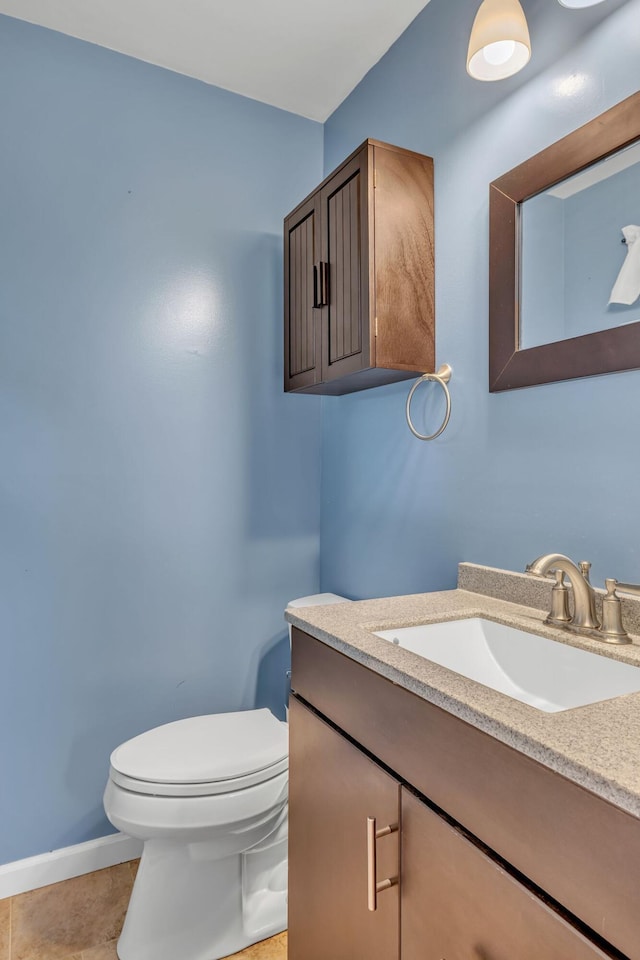 bathroom with tile patterned floors, vanity, and toilet