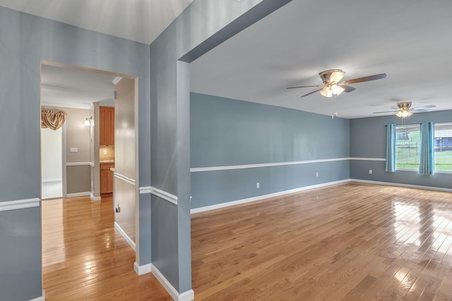 unfurnished room with ceiling fan and light hardwood / wood-style flooring