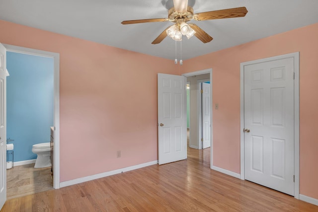 unfurnished bedroom featuring connected bathroom, ceiling fan, and light wood-type flooring