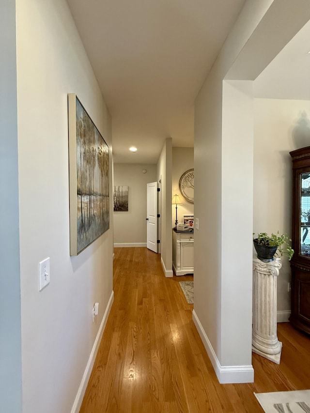 corridor with light hardwood / wood-style floors